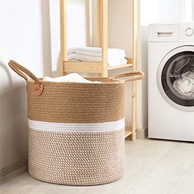 Natural jute laundry basket with handles for easy carrying.