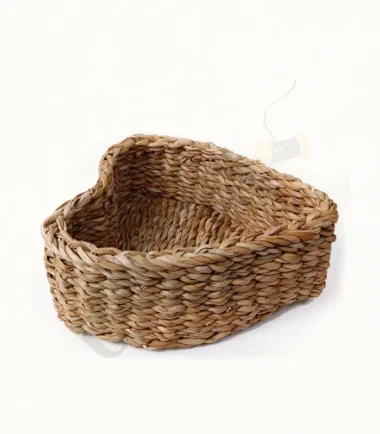 Handwoven seagrass heart-shaped basket for decorative storage.